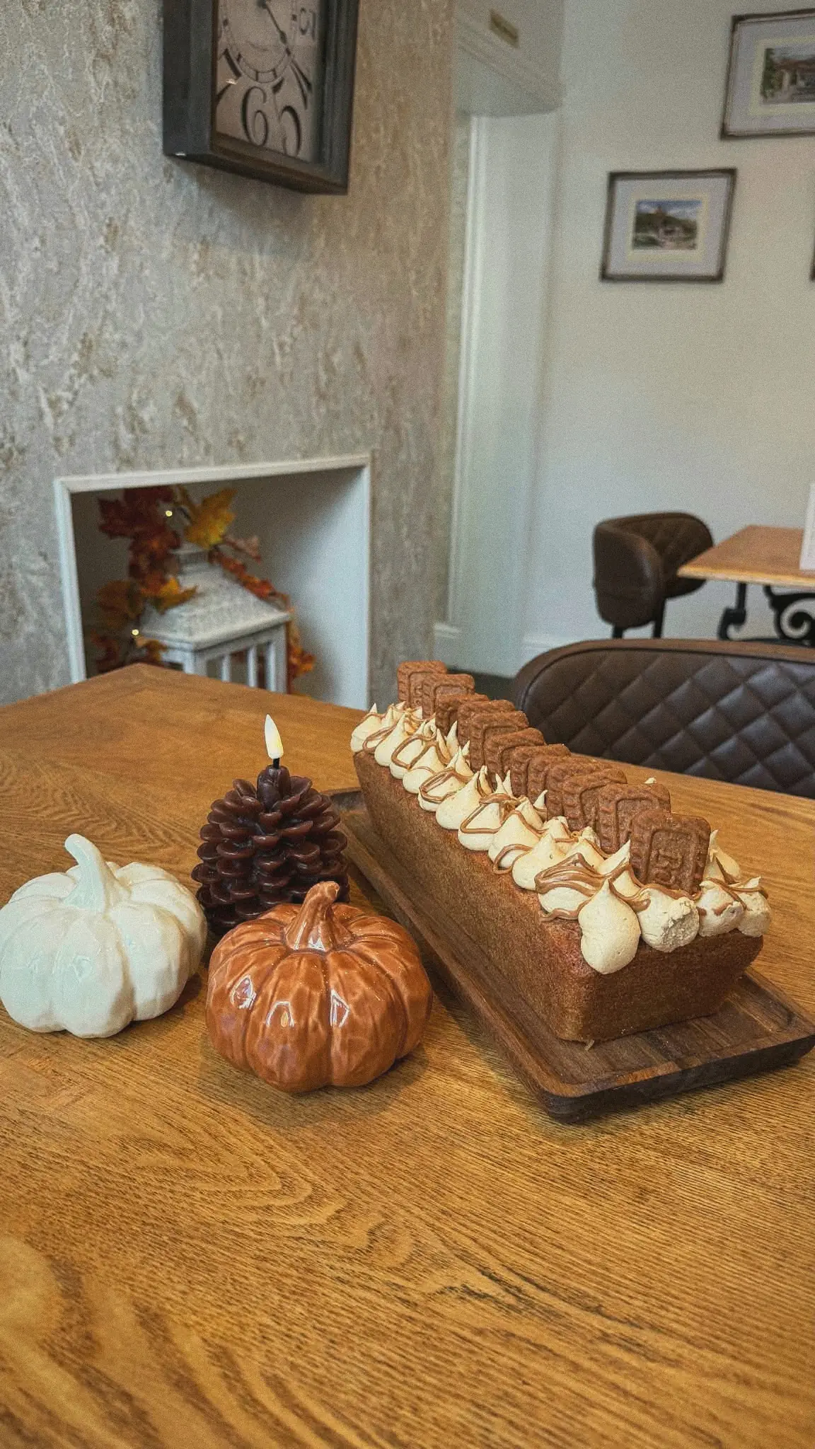 Biscoff loaf cake with autumn pumpkins on a table
