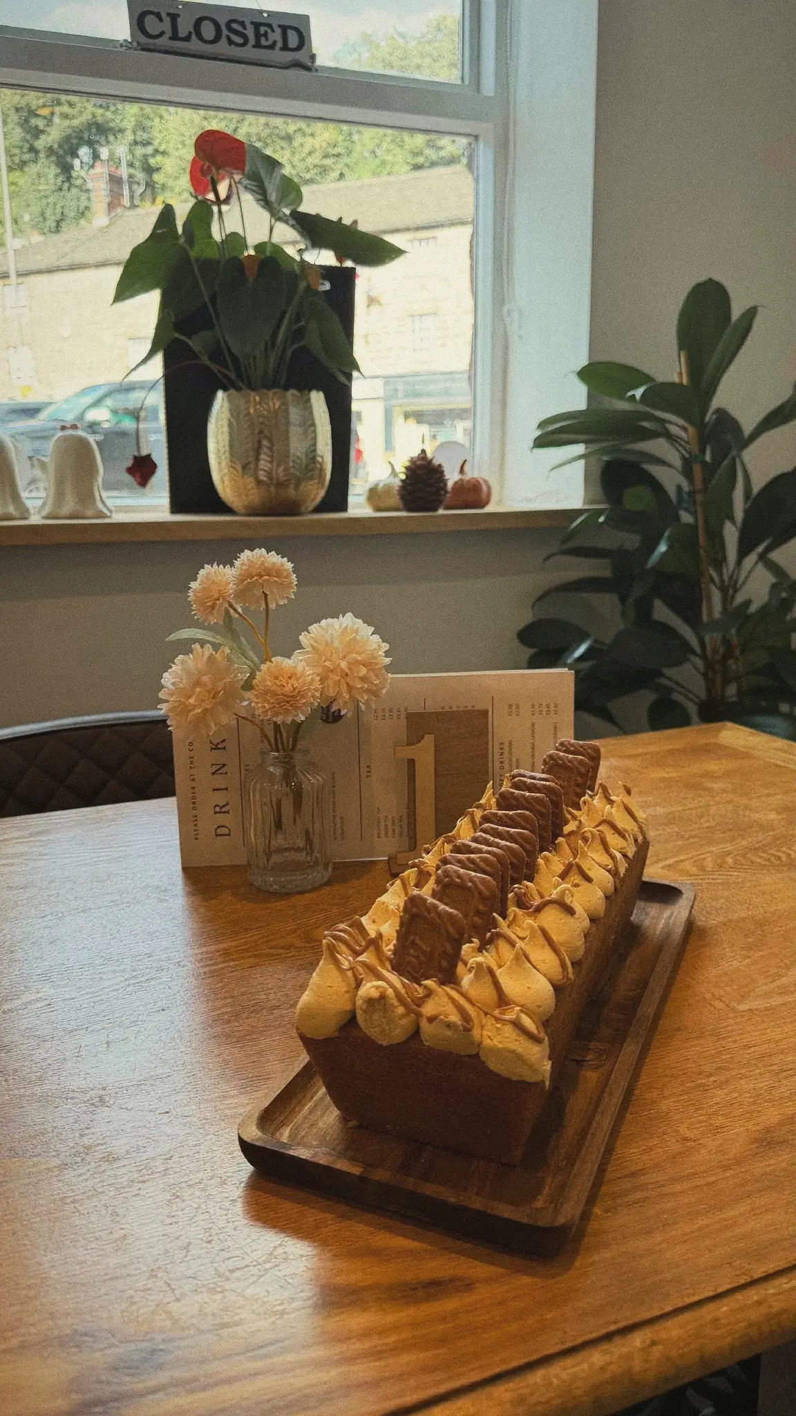 Lotus Biscoff loaf cake on a wooden board by the window